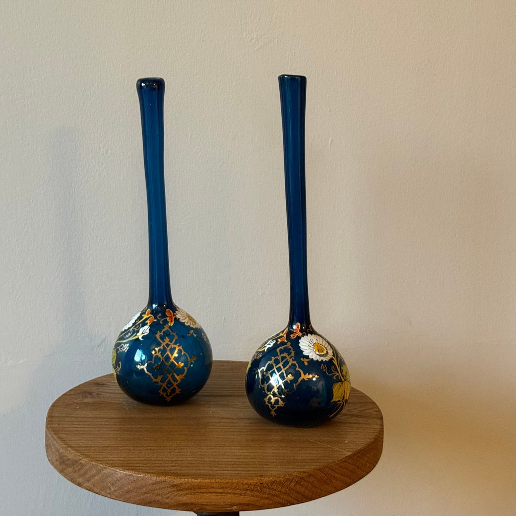 Pair of hand blown blue glass 19th century Persian rose water sprinklers/ bud vases, hand painted enamelled flower and gilt decoration. Measures 29.5cm tall.