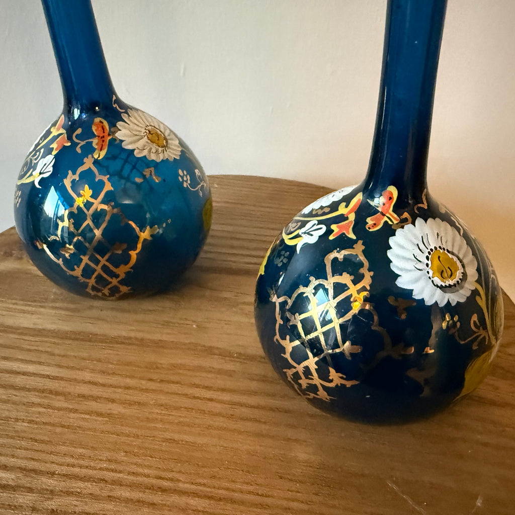 Pair of hand blown blue glass 19th century Persian rose water sprinklers/ bud vases, hand painted enamelled flower and gilt decoration. Measures 29.5cm tall.