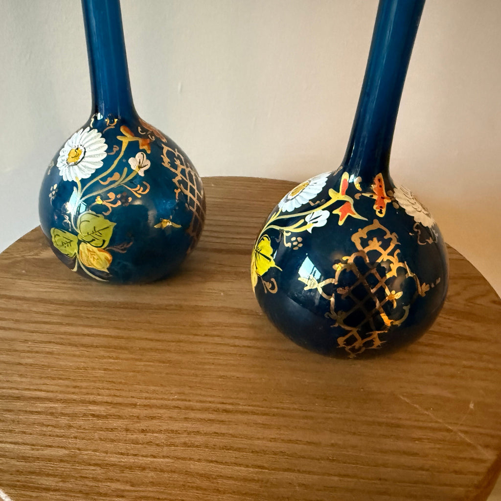 Pair of hand blown blue glass 19th century Persian rose water sprinklers/ bud vases, hand painted enamelled flower and gilt decoration. Measures 29.5cm tall.