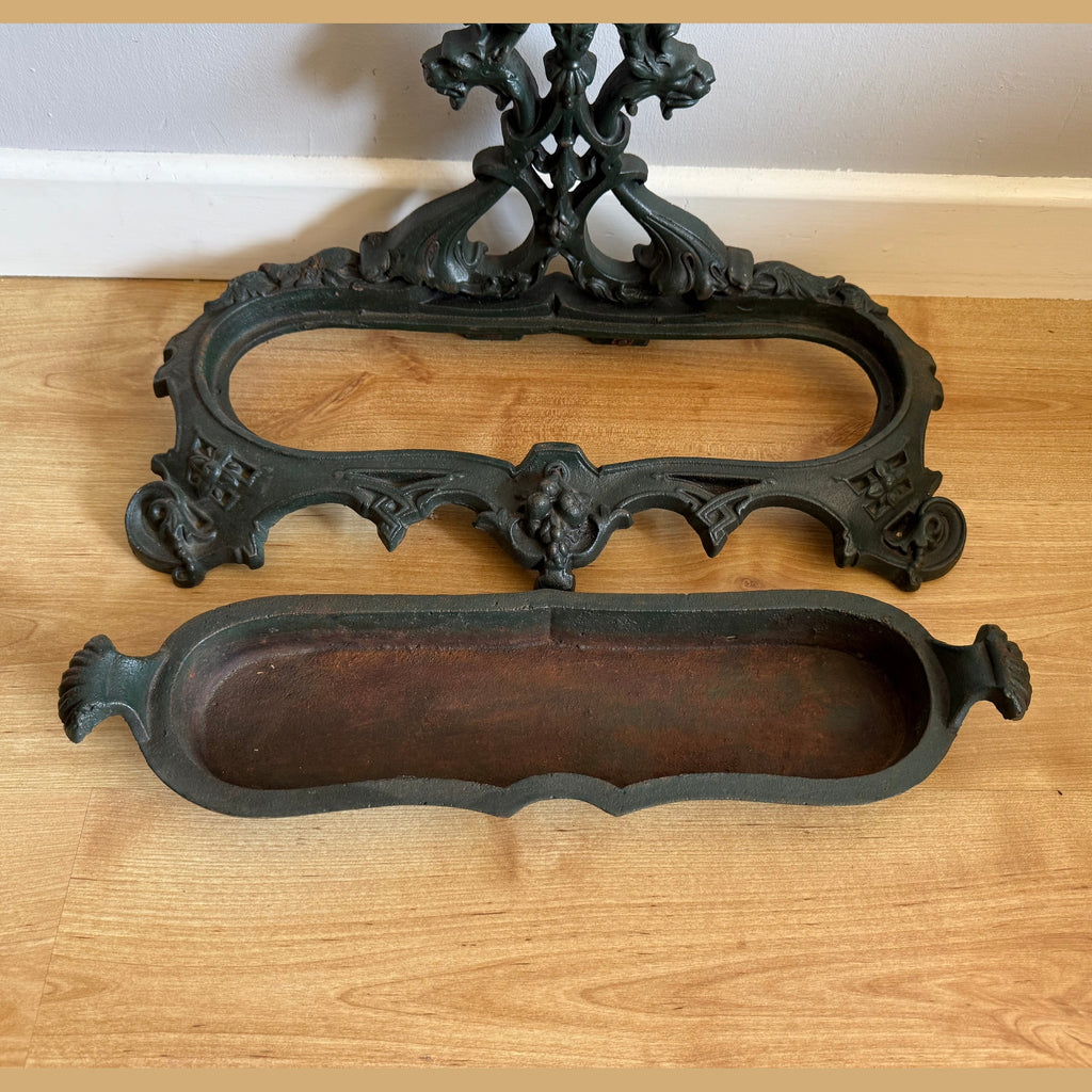 Detachable tray and ornate base of dark green cast iron stick stand